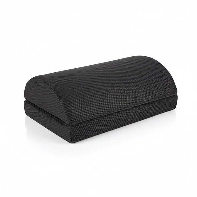 The Remote Desk black contoured memory foam footrest with a soft fabric cover for ergonomic under-desk support.