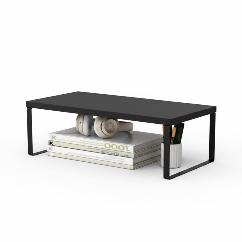 The Remote Desk black wooden monitor riser with storage space for books, headphones, and pens on a white background